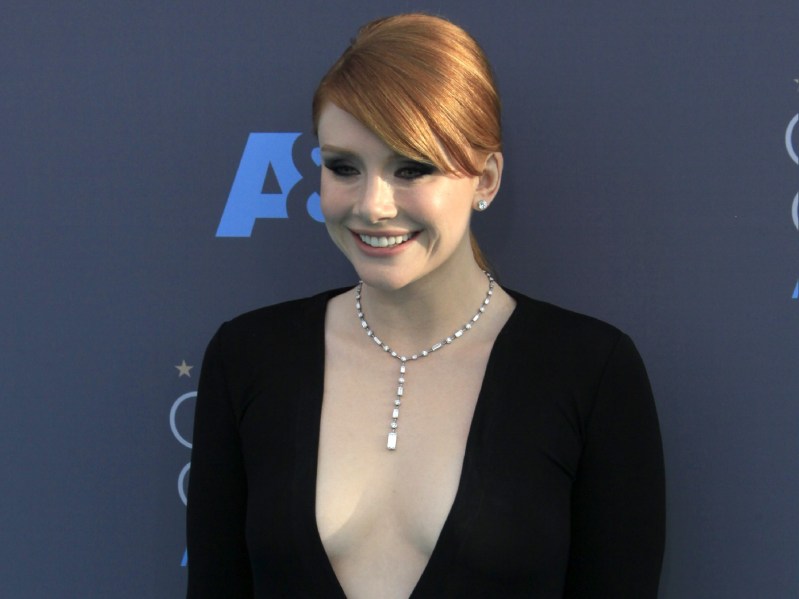 Bryce Dallas Howard wears a black dress with a plunging neckline on the red carpet