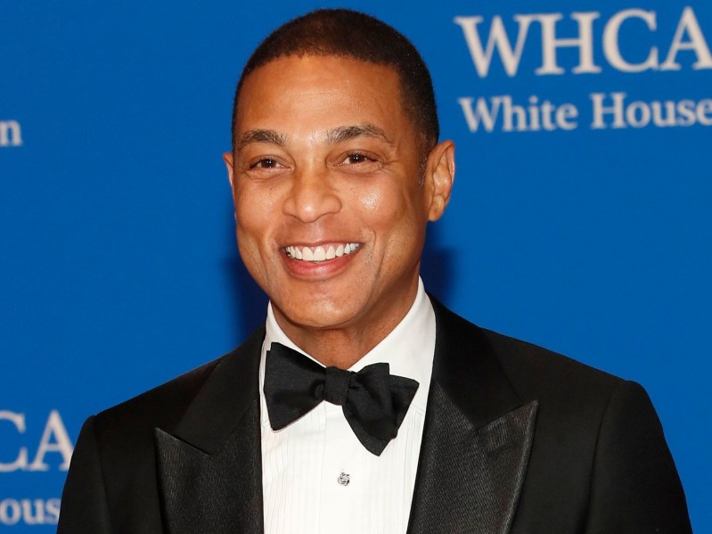 Closeup of Don Lemon wearing white shirt with black blazer and bow tie, smiling with teeth for the camera