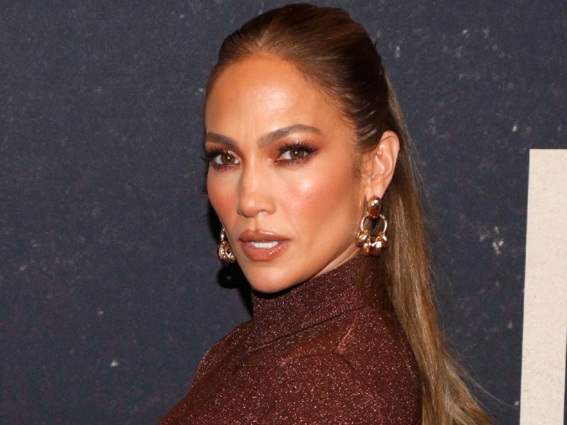 Jennifer Lopez wears a bronze colored two-piece dress to a film premiere