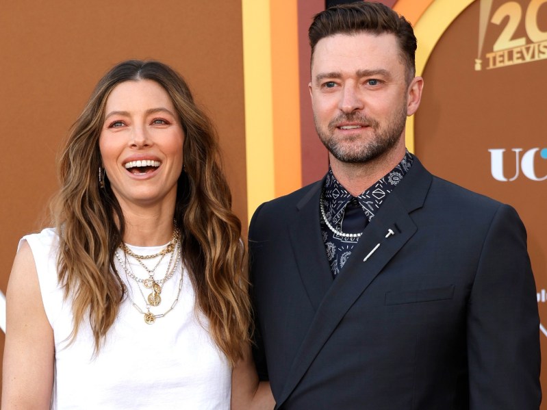 Jessica Biel (L) wearing white top and Justin Timberlake (L) wearing navy blue suit