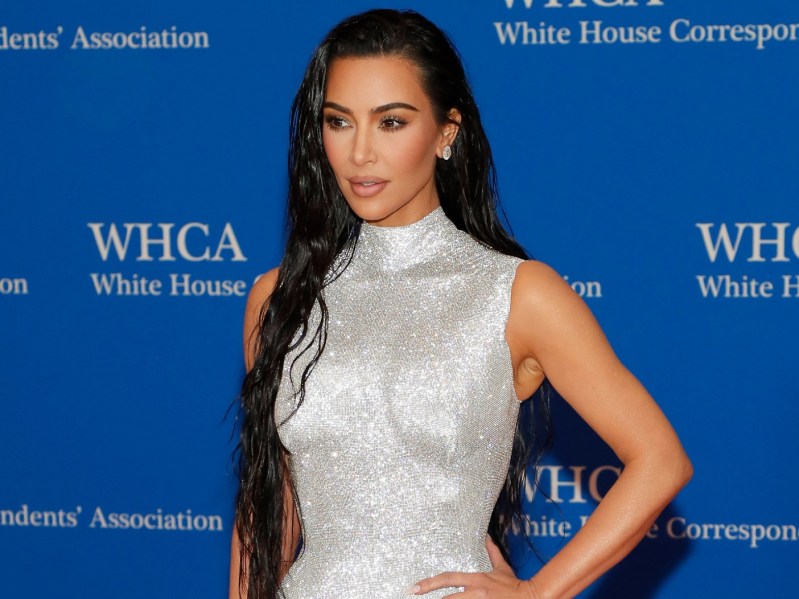 Kim Kardashian posing at White House Correspondent's Dinner, wearing mock-neck sequin dress