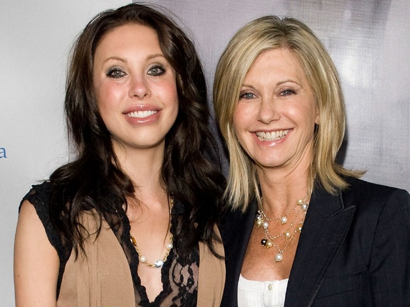 Chloe Lattanzi (L) wearing tan and black top, with Olivia Newton-John (R) wearing white top and black jacket. Both women are smiling