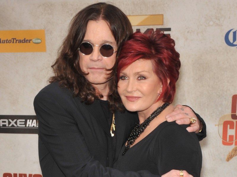 Ozzy Osbourne (L) and Sharon Osbourne (R) embrace each other for the cameras while wearing all black outfits