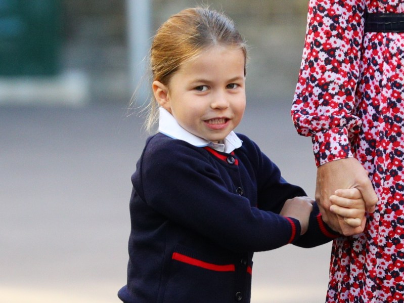 Princess Charlotte wearing a navy blue sweater with red trim