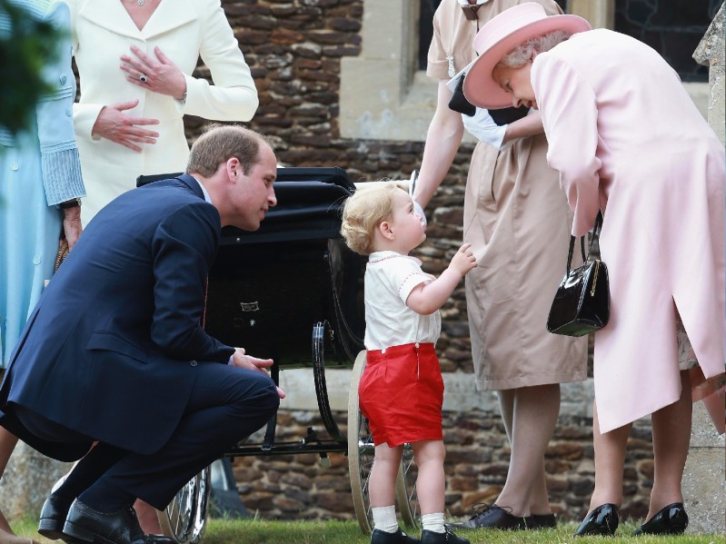 Prince William and Prince George have a conversation with Queen Elizabeth, who is dressed in pink
