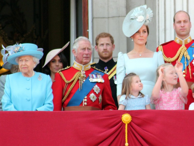 (From left to right) Queen Elizabeth, Meghan Markle, Prince Charles, Prince Harry, Princess Charlotte, Kate Middleton stand on the balcony of Buckingham Palace