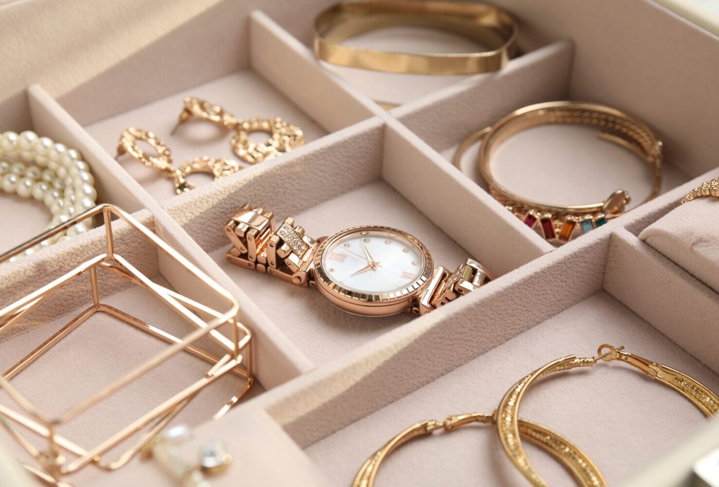 Various gold jewelry in a jewelry box.