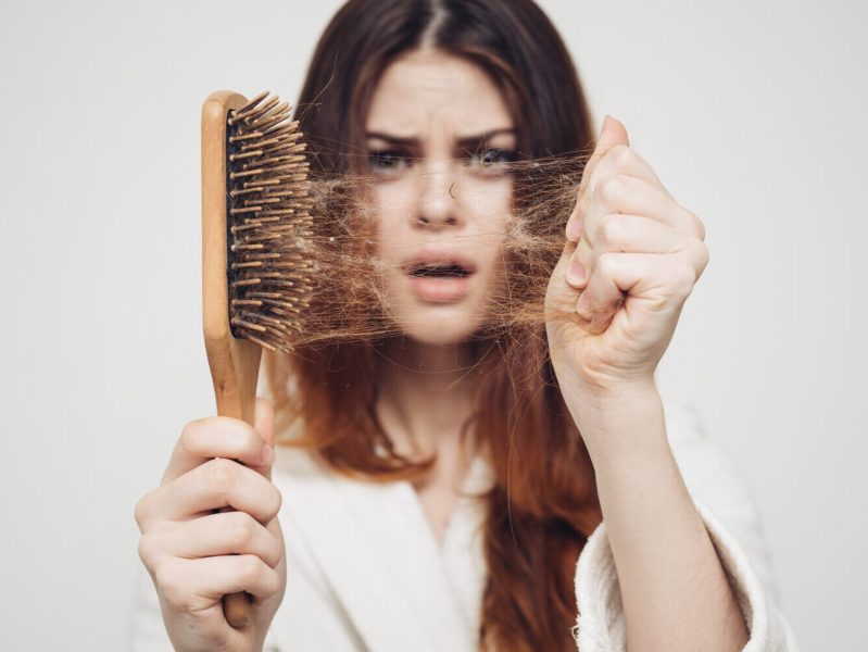 Woman shocked by the amount of hair in her hair brush.