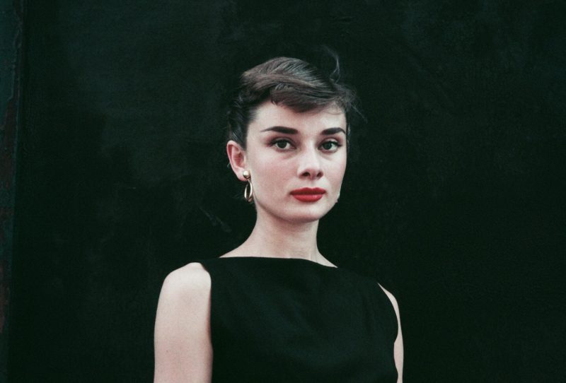 Audrey Hepburn in a black sleeveless dress, circa 1955.
