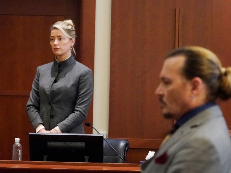 Amber Heard stands at a distance from ex husband Johnny Depp in court