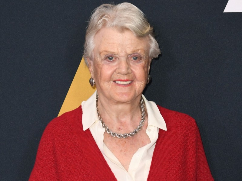 Angela Lansbury wearing white dress shirt and red sweater