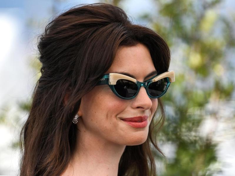 Anne Hathaway retro half-up, half-down hairdo, cat-eye sun glasses