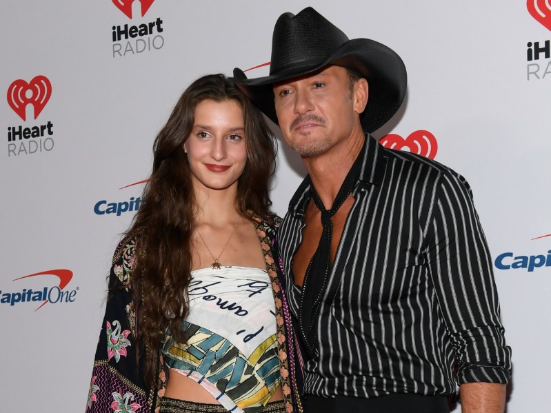 Audrey McGraw (L) wearing patterned white top and Tim McGraw, wearing striped top and black cowboy hat