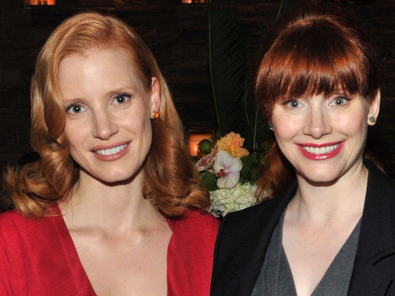 Jessica Chastain (left) wears red as she poses with Bryce Dallas Howard (right) who wears a black blazer