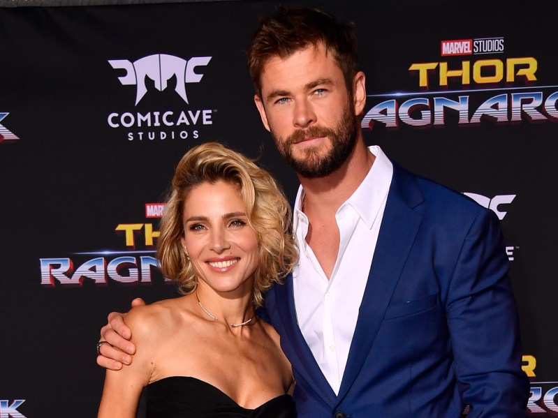 Elsa Pataky (L) wearing strapless black gown and Chris Hemsworth (R) wearing navy blue blazer over button-down white shirt