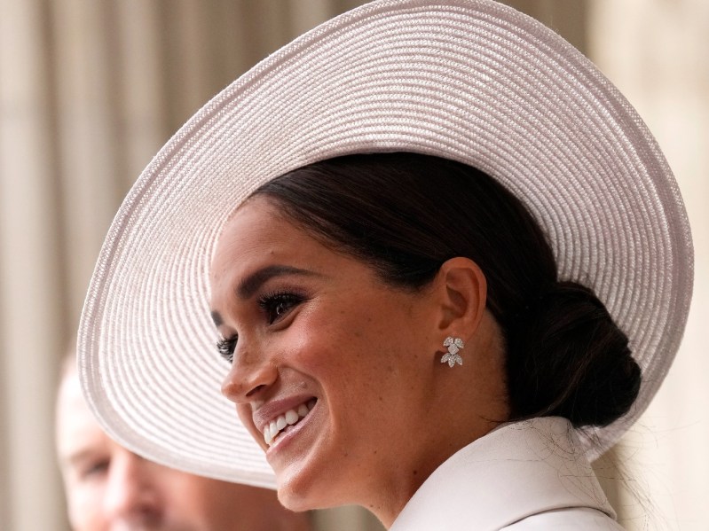 Meghan Markle wears a white hat and coat at the National Service of Thanksgiving in London