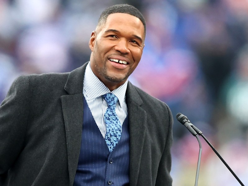 Michael Strahan smiles in blue tux
