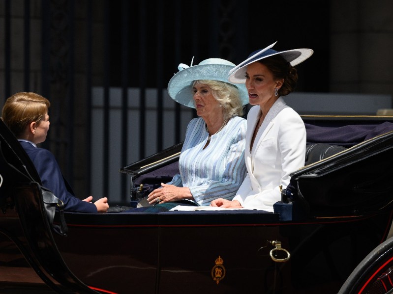 Prince George sits opposite mother Kate Middleton and Camilla Parker Bowles in a carriage