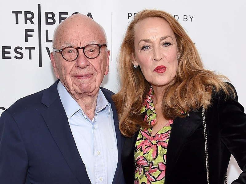 Rupert Murdoch (L) wearing deep blue blazer over white dress shirt, standing next to Jerry Hall, who is wearing a patterned top with a black jacket
