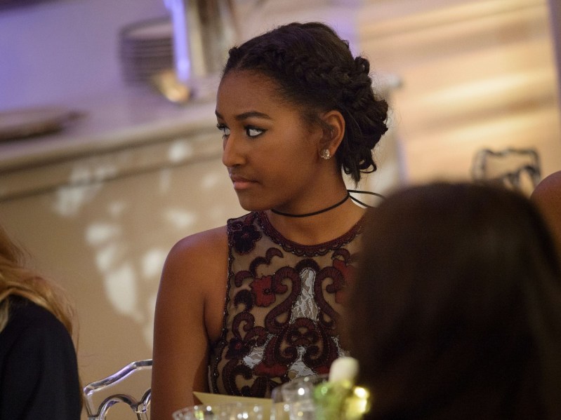 Sasha Obama looks off to her right while wearing a formal dress