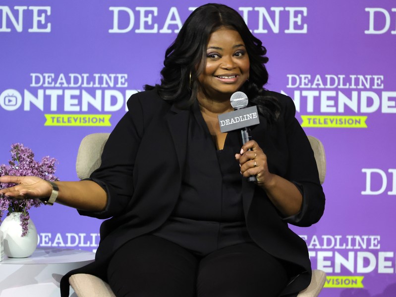 Octavia Spencer sitting in a chair, holding a microphone at a Q & A