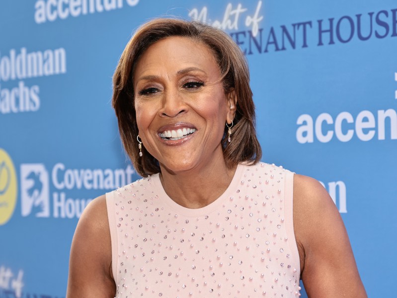 Robin Roberts smiling in a pink dress.