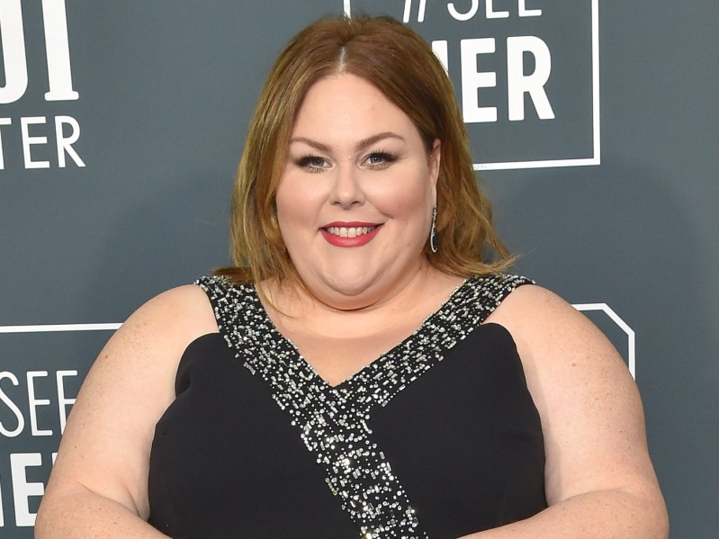 Chrissy Metz smiles while wearing black dress with sparkly trim