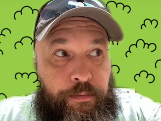 TikToker Gen X Council wears a hat against a cartoon bush background