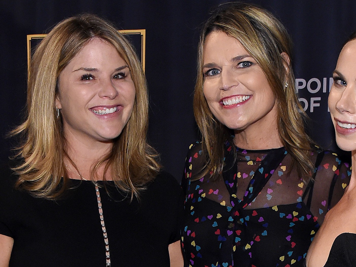 Jenna Bush Hager (L) and Savannah Guthrie smiling against black backdrop