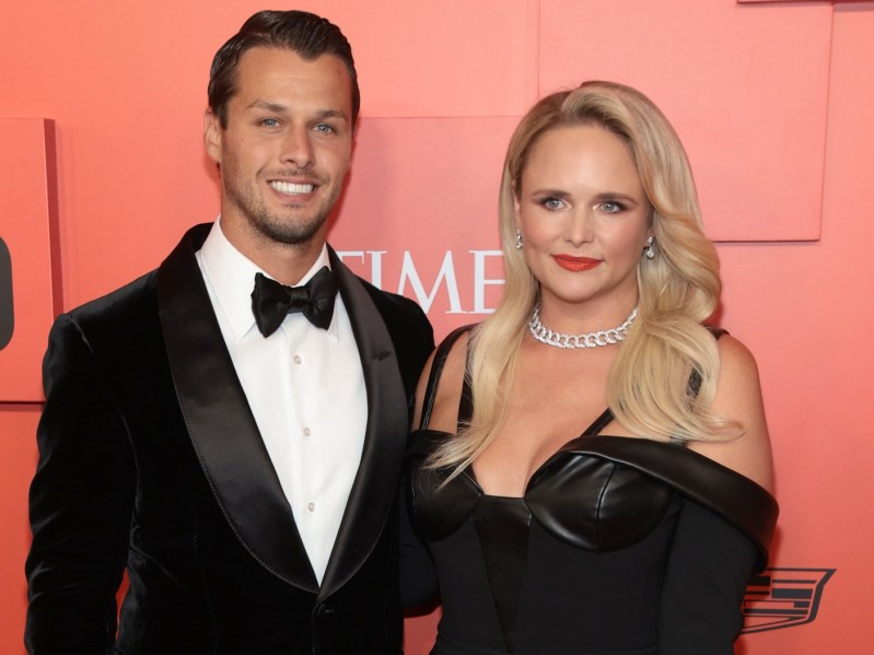 Miranda Lambert (R) wearing black leather gown standing next to Brendan McLoughlin, who is dressed in a classic black suit and bowtie