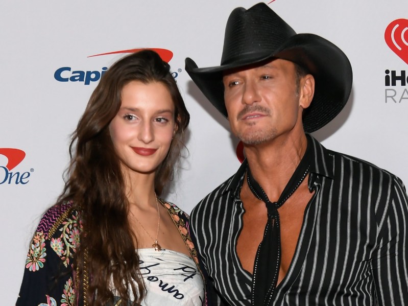 Audrey McGraw (L) standing next to Tim Mcgraw against a white background