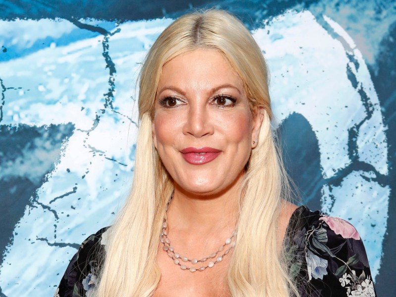 Closeup of Tori Spelling against icy blue backdrop