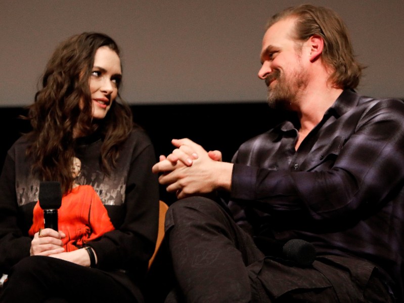 Winona Ryder and David Harbour share a look onstage
