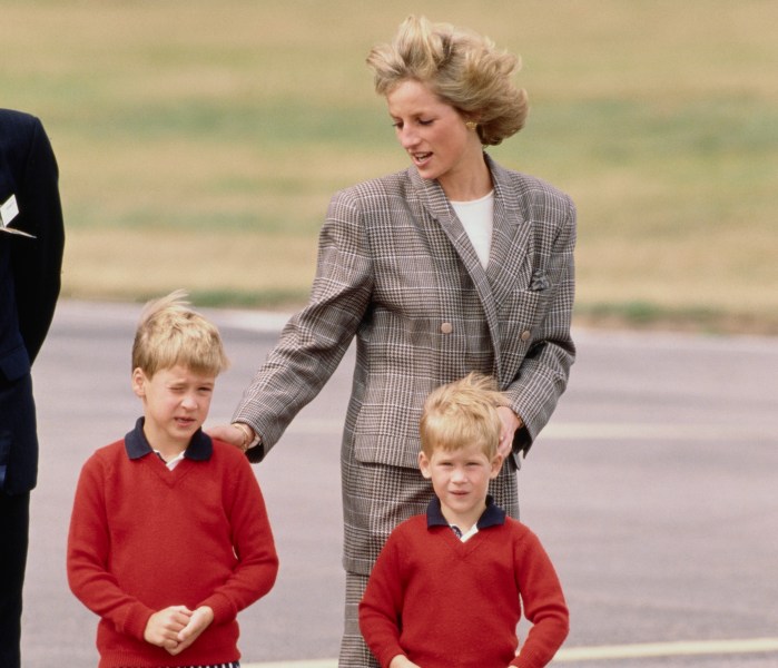 archive photo of Princess Diana walking with Princes William and Harry on the tarmac