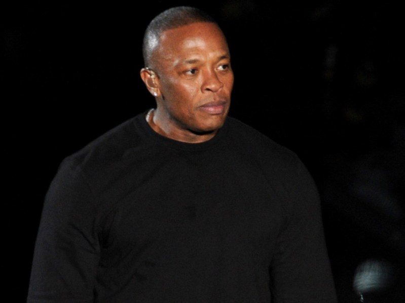 Dr. Dre looking ahead in black shirt against black backdrop