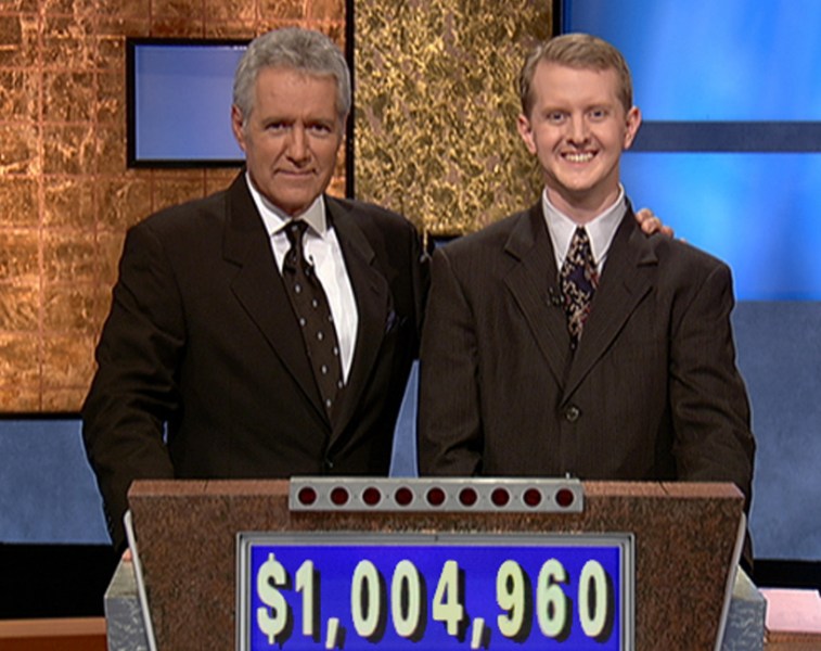 Alex Trebek with arm around Ken Jennings after reaching $1 million Jeopardy winnings