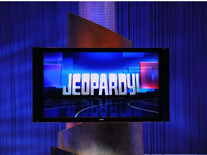 TV monitor displaying the "Jeopardy!" logo against a dark blue backdrop