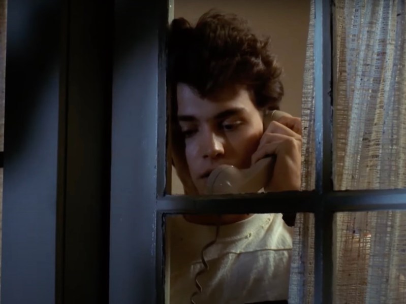 screenshot of Johnny Depp on the phone in a window in the 1984 film Nightmare on Elm Street