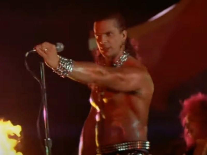 Screenshot from 'Lost Boys' of shirtless man singing