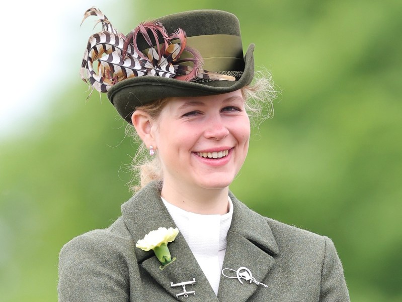 Lady Louise Windsor smiles in army green top and matching hat