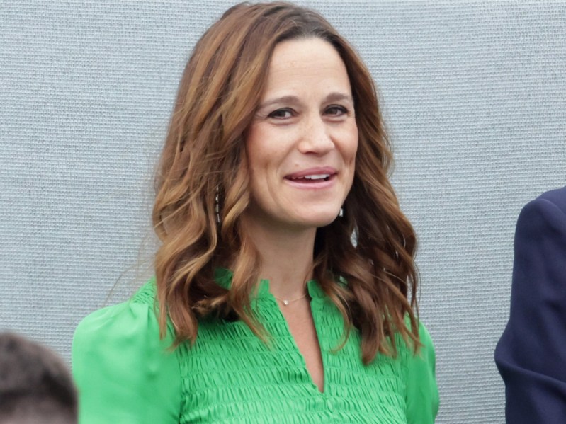 Pippa Middleton smiling in night green smock dress