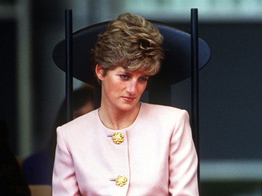 1991 photo of Princess Diana in a pink blouse sitting in a black chair
