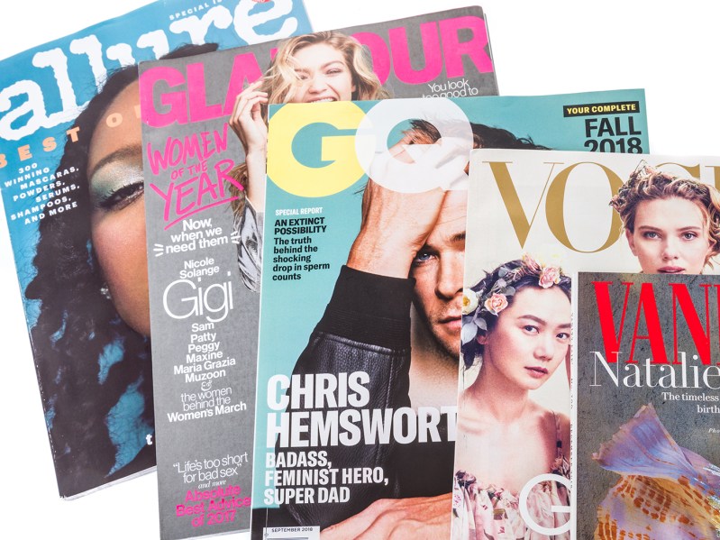 A spread of magazines on a white background. From left to right: Allure, Galmour, GQ, Vogue, Vanity Fair