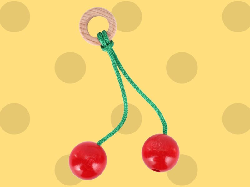 A clacker toy with red balls and green string