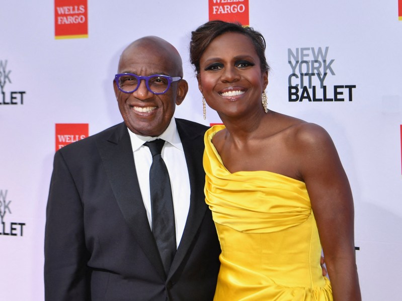 Al Roker in a grey suit smiling with Deborah Roberts in a yellow dress