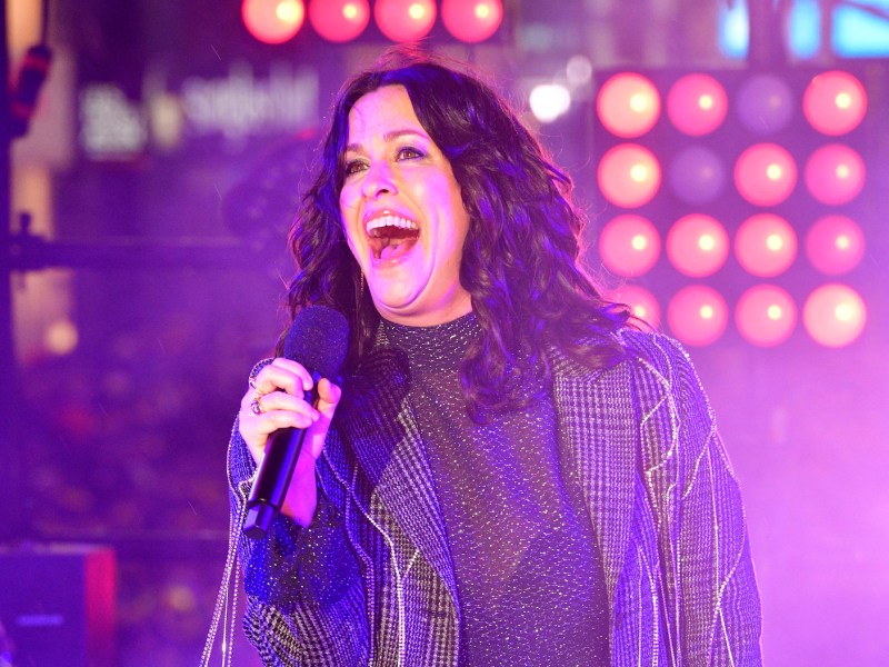 Alanis Morissette singing on stage in 2020