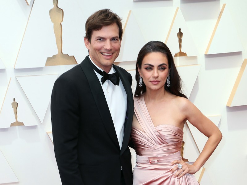Ashton Kutcher in a tuxedo with Mila Kunis in a pink dress