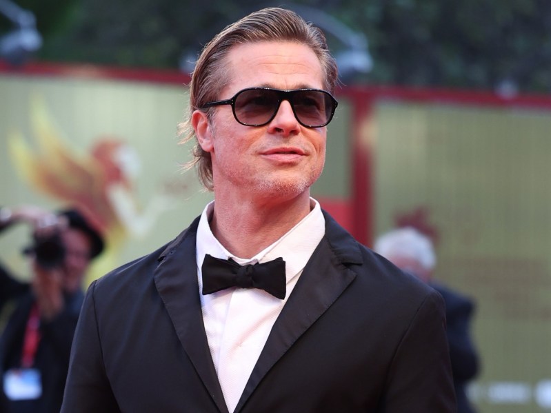Brad Pitt wearing black suit with matching bowtie and dark sunglasses