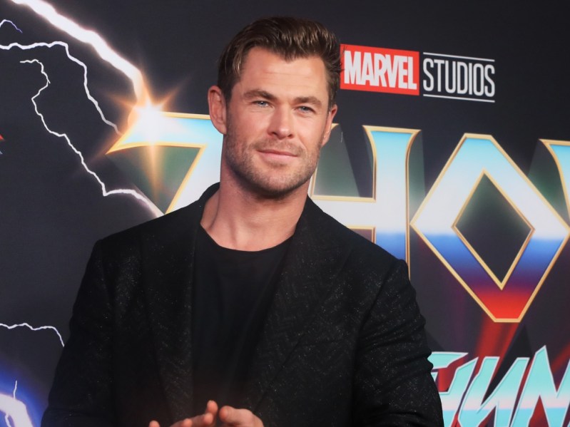 Chris Hemsworth poses in all-black suit