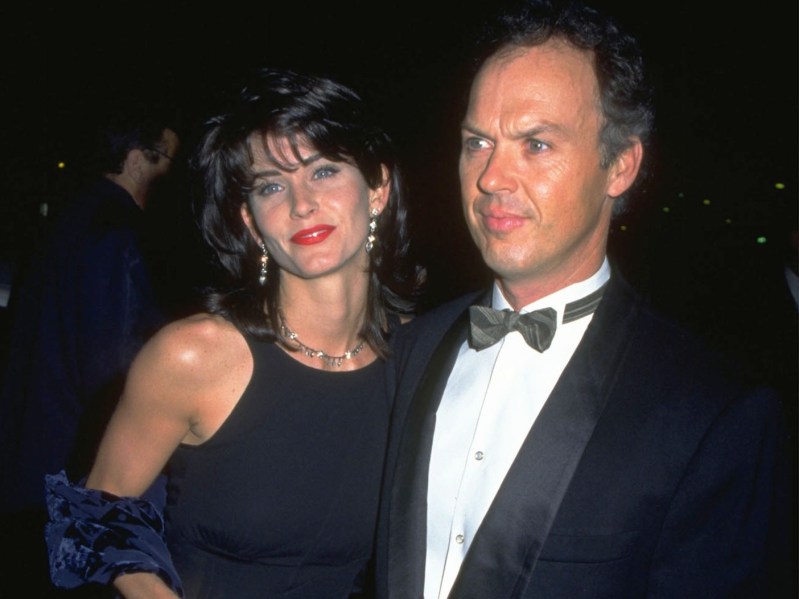 Dark photo of Courteney Cox (L) and Michael Keaton dressed for a black-tie event
